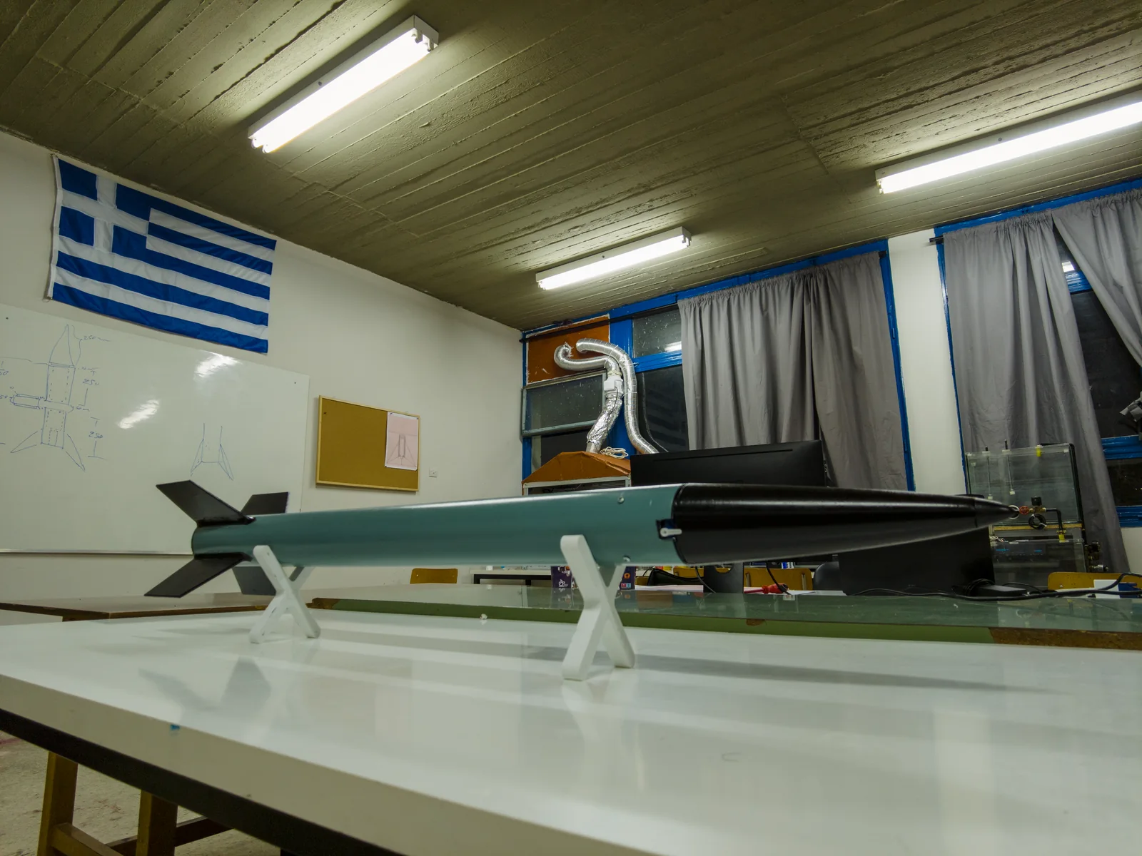 The GENESIS rocket on stands on the HEPHAESTUS workshop bench