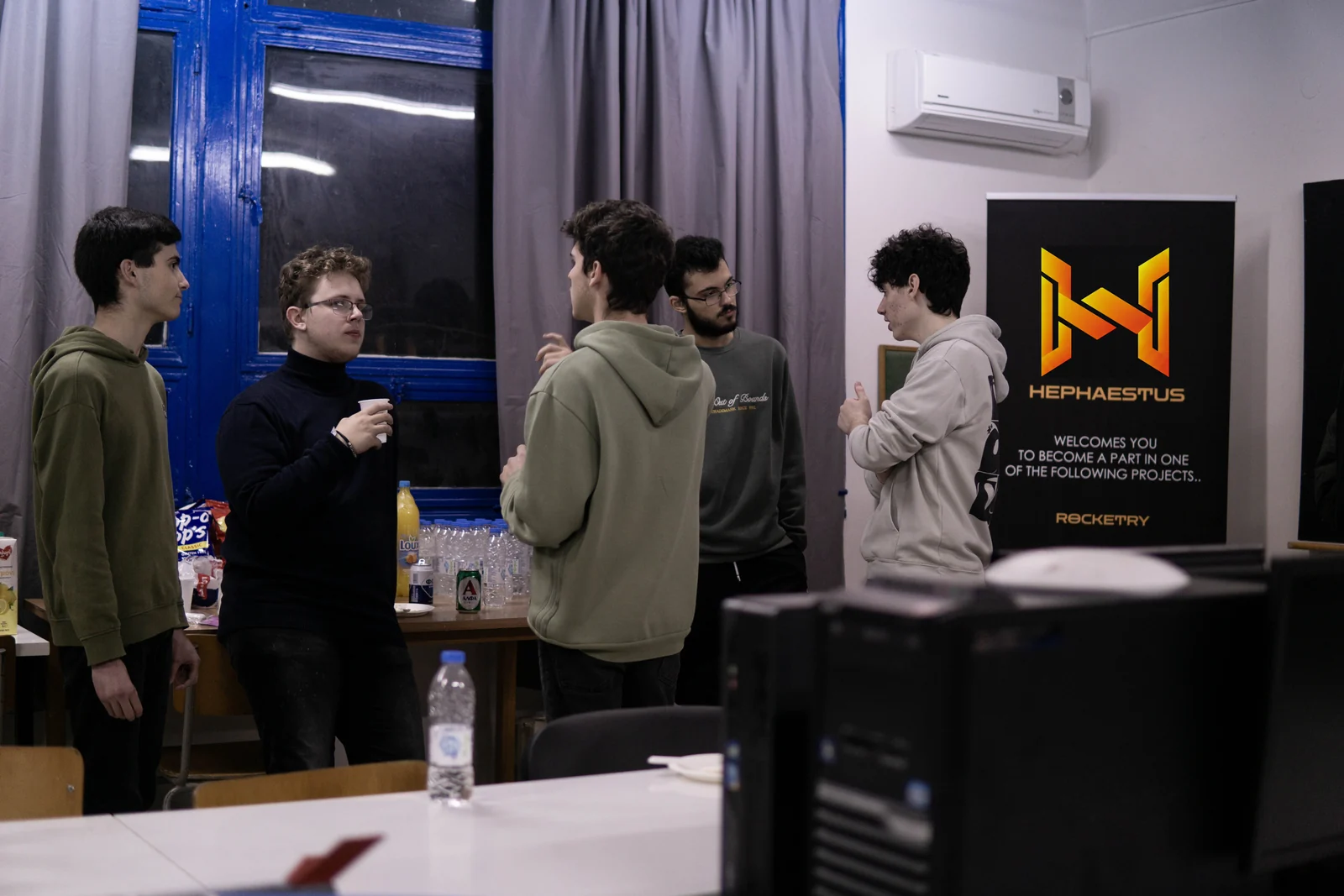 HEPHAESTUS members talking at a team meeting