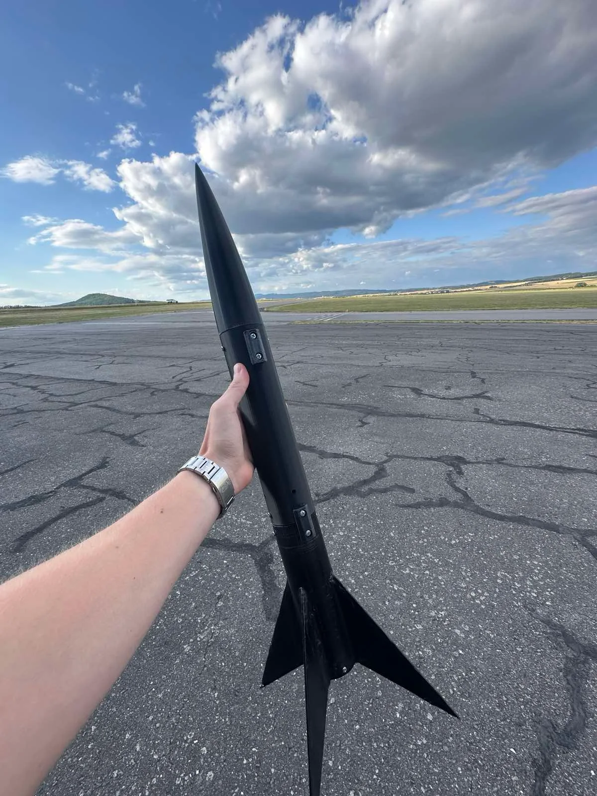 The black SARISSA rocket being held at the CRC 2026 launch site